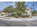 Landscaped corner lot showcases a well-maintained single-story home with mature trees at 7465 Widewing Dr, North Las Vegas, NV 89084