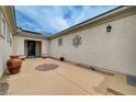 View of the property's courtyard entrance featuring a unique decor and desert landscaping at 7606 Grove Acre Ct, Las Vegas, NV 89131