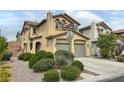 View of the home's facade showcasing its architectural style, desert landscaping, and street sign at 7815 Shingle Beach St, Las Vegas, NV 89166
