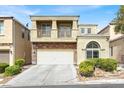 Two-story home with a private balcony, stone accents, manicured landscaping, and an attached two-car garage at 8015 Maple Park St, Las Vegas, NV 89131