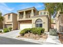 Two-story home with stone accents, a balcony, two-car garage, and a well-maintained front yard at 8015 Maple Park St, Las Vegas, NV 89131