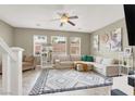 Comfortable living room with neutral walls, a ceiling fan, ample natural light, and stylish area rug at 8015 Maple Park St, Las Vegas, NV 89131