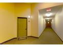 Condo hallway features well-lit entrance with carpet and a welcome mat at the door at 8777 Maule Ave # 3116, Las Vegas, NV 89148