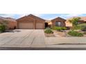 Charming single-story home with a three-car garage, desert landscaping, and neutral color palette at 940 Rifle Dr, Henderson, NV 89002