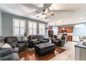 Spacious living room with wood floors, ceiling fan and large windows at 10229 Mayflower Bay Ave, Las Vegas, NV 89166