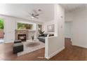 Bright living room featuring a fireplace, modern ceiling fan, and contemporary furnishings at 10505 Jeremy Ridge Ave, Las Vegas, NV 89144