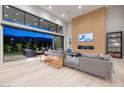 Spacious living room with floor-to-ceiling windows and access to outdoor living space at 10781 Agate Cliffs Ave, Las Vegas, NV 89135
