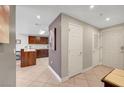 Hallway leading to kitchen with a view of wooden cabinets, stone countertops, and tile flooring at 150 Las Vegas Blvd # 1503, Las Vegas, NV 89101