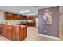Spacious kitchen with warm wood cabinets, stainless steel appliances, and tile flooring at 150 Las Vegas Blvd # 1503, Las Vegas, NV 89101