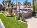Beautiful one-story home showcasing a well-manicured lawn, mature trees, and a two-car garage at 1813 Skyline Dr, Las Vegas, NV 89117