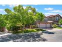 Charming two-story home featuring mature trees, green lawn and a two-car garage at 2008 Aspen Oak St, Las Vegas, NV 89134