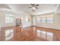 Open-concept living room featuring lots of natural light and beautiful laminate floors at 202 Twin Creek St, Henderson, NV 89074