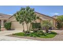 Charming single-story home with manicured front yard, desert landscaping and attached two-car garage at 2107 Desert Woods Dr, Henderson, NV 89012