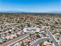 Expansive aerial view of a residential community with city skyline and mountains in the distance at 217 Turkey Creek Way, Henderson, NV 89074