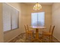Cozy dining area with natural light, a wooden table and two chairs at 2173 Point Mallard Dr, Henderson, NV 89012