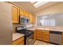 Functional kitchen features stainless steel appliances and a convenient pass-through window at 2173 Point Mallard Dr, Henderson, NV 89012