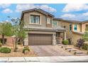 Attractive two-story home showcasing a two-car garage and meticulously landscaped front yard at 2711 Evolutionary Ln, Las Vegas, NV 89138