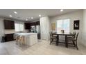 Bright eat-in kitchen featuring a center island, stainless steel appliances, and dark cabinetry at 2924 Sunday Silence Rd, North Las Vegas, NV 89086