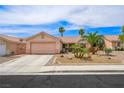 Charming single-story home with desert landscaping, mature palm trees and two-car garage at 3121 Fontana Colony Ct, North Las Vegas, NV 89031