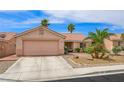 Charming single-story home with desert landscaping, mature palm trees and two-car garage at 3121 Fontana Colony Ct, North Las Vegas, NV 89031