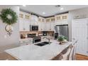 Bright kitchen with white cabinetry, stainless steel appliances, and marble countertops at 3185 Mura Del Prato Ave, Henderson, NV 89044
