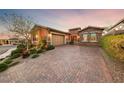 Charming home featuring a brick driveway and lush landscaping at 35 Via Rizzuto, Henderson, NV 89011