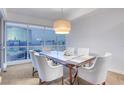 Bright dining room with big windows showcasing city views and a modern chandelier at 4525 Dean Martin Dr # 2109, Las Vegas, NV 89103
