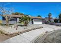 Attractive single-story home with a two-car garage, xeriscaping, and a mature tree at 4556 Kenilworth Ct, Las Vegas, NV 89147