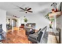 Inviting living room with hardwood floors, ceiling fan, and ample natural light at 4556 Kenilworth Ct, Las Vegas, NV 89147