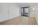 Spacious living room with light wood floors and sliding glass doors offering access to a balcony at 5171 Lindell Rd # 201, Las Vegas, NV 89118
