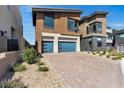 The home's exterior shows a spacious driveway, the two-car garage and manicured landscaping at 5364 Succulent Rose Dr, Las Vegas, NV 89135