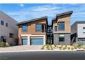 Modern exterior showcasing the two-car garage, unique design and landscaping at 5364 Succulent Rose Dr, Las Vegas, NV 89135