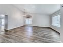 Bright and airy living room featuring hardwood floors, vaulted ceilings, and large windows at 5639 Guiding Star Cir, North Las Vegas, NV 89031