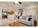 Inviting living room with modern gray-toned decor, tile flooring and an open layout to the kitchen at 67 Dow Jones St # 2, Henderson, NV 89074