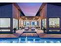 Inviting outdoor patio with modern furniture, water feature, and seamless transition to the luxurious interior spaces at 826 Bolide St, Las Vegas, NV 89138