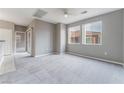 Bright living room with neutral walls, plush carpeting, and view of the exterior at 9303 Gilcrease Ave # 1013, Las Vegas, NV 89149