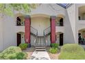 Inviting condo exterior featuring dual staircases leading to upper units with well-maintained landscaping and modern design at 950 Seven Hills Dr # 1921, Henderson, NV 89052