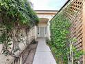Inviting entrance featuring a quaint walkway adorned with mature landscaping at 1006 Winding Hill St, Henderson, NV 89002
