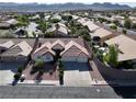 Inviting single-story home with desert landscaping, tile roof, and a convenient three-car garage at 1006 Winding Hill St, Henderson, NV 89002