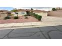 Well-maintained single-story home with a two-car garage and low maintenance desert landscaping at 1006 Winding Hill St, Henderson, NV 89002