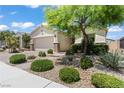 Charming single-story home features desert landscaping with stone accents and a two car garage at 10416 Skye Arroyo Ave, Las Vegas, NV 89166