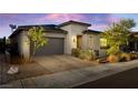 Contemporary home with a brick driveway, desert landscaping, and a two-car garage, offering modern curb appeal at 11672 Barga Ct, Las Vegas, NV 89138