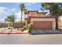 Attractive two-story home featuring a tile roof, lush landscaping, and a convenient two-car garage at 1220 Padre Serra Ln, Las Vegas, NV 89134