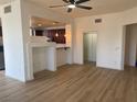 Bright living room with light wood flooring and adjoining kitchen with a convenient breakfast bar at 15 E Agate Ave # 202, Las Vegas, NV 89123