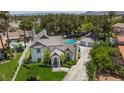 Aerial view showcasing the house's layout, including a pool, manicured lawn and mature trees at 15 Pheasant Ridge Dr, Henderson, NV 89014