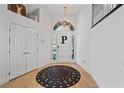 Bright foyer with white walls, wood floors, and a striking round rug at 15 Pheasant Ridge Dr, Henderson, NV 89014