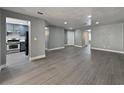 Open concept living room with kitchen view featuring stainless steel appliances and gray cabinets at 1509 Linnbaker Ln # 102, Las Vegas, NV 89110