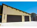 Spacious three-car garage with dark brown doors and a concrete driveway at 1801 S Manzanita Dr, Pahrump, NV 89048