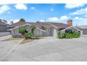 Charming single-story home featuring a spacious front yard with mature landscaping and a large driveway at 1905 E Oakey Blvd, Las Vegas, NV 89104