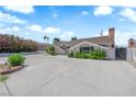 Charming single-story home featuring a spacious front yard with mature landscaping and a large driveway at 1905 E Oakey Blvd, Las Vegas, NV 89104